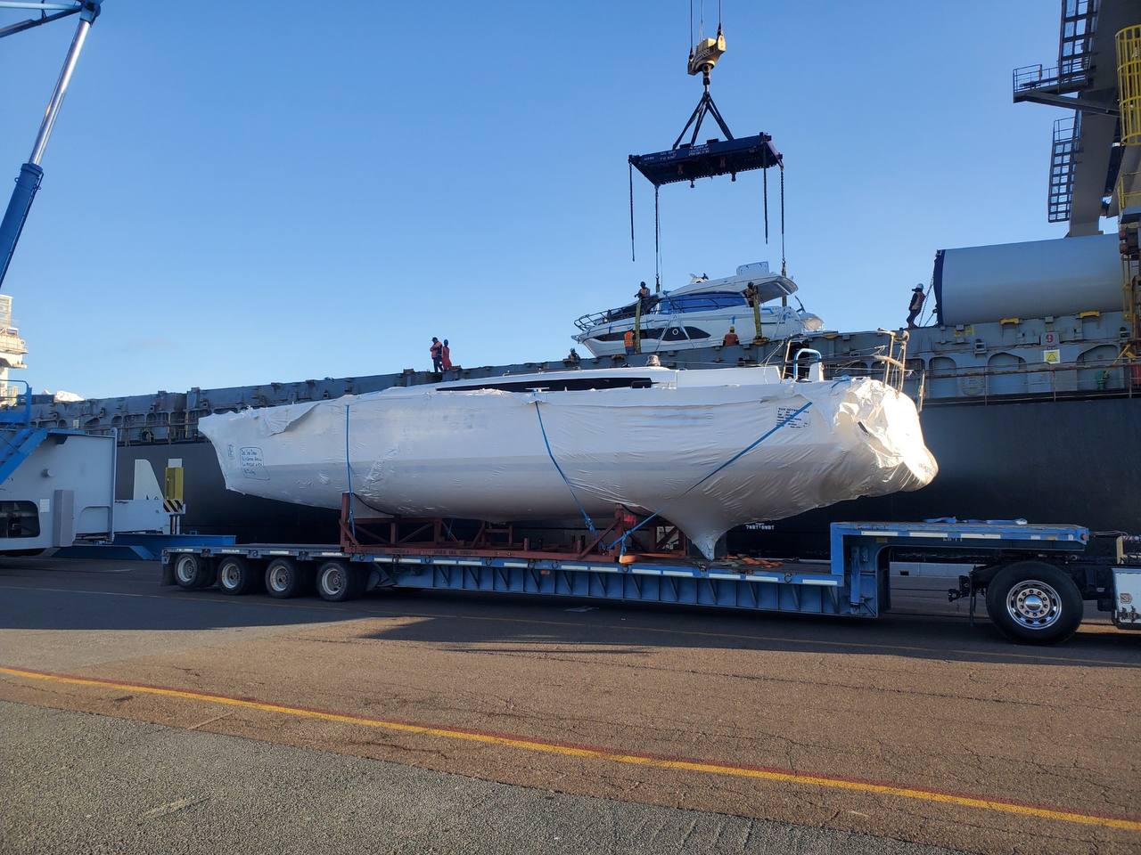 Boat transport crew preparing a vessel